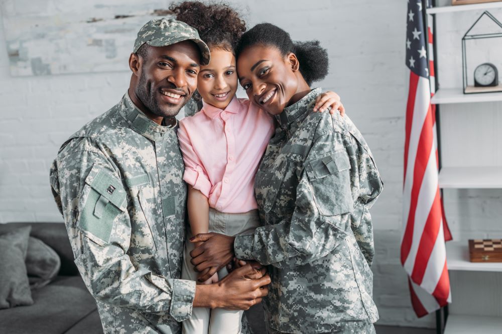 father and mother in military uniform with daughter