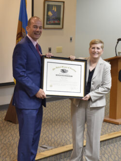 General Irwin and Acting Director Craig Brown holding up a framed certificate 