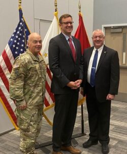 Jason Fahy pictured center, TJ Kenny on the right, service man in uniform to the left